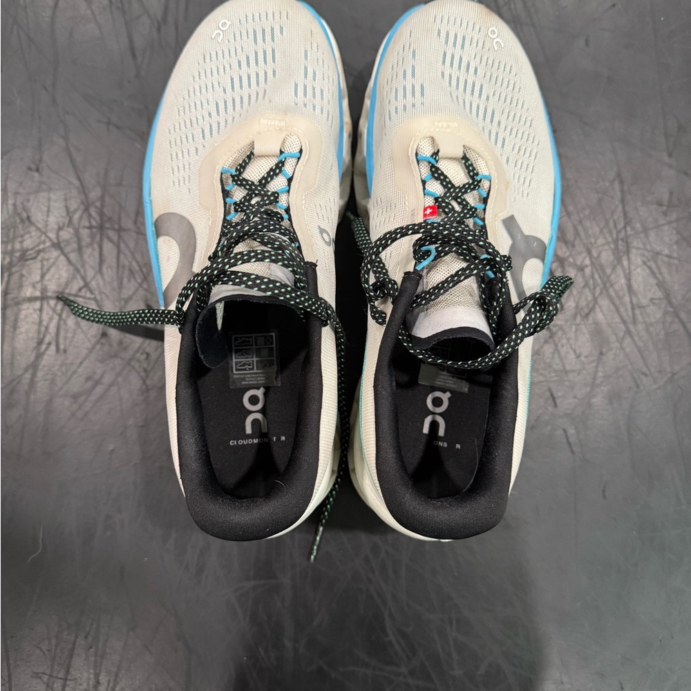 On Running Cream and Black Athletic Shoes
